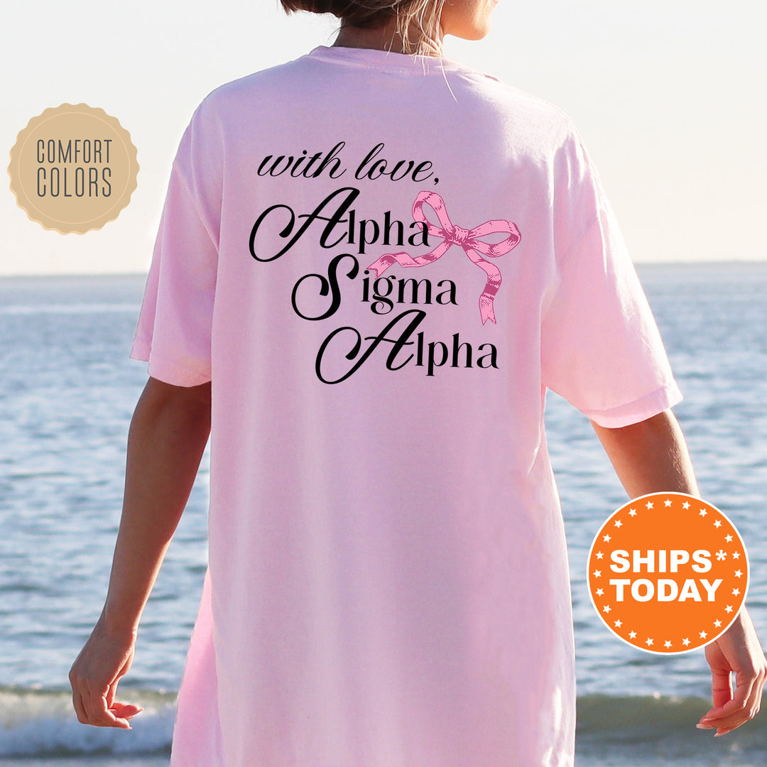 a woman standing on a beach wearing a pink shirt