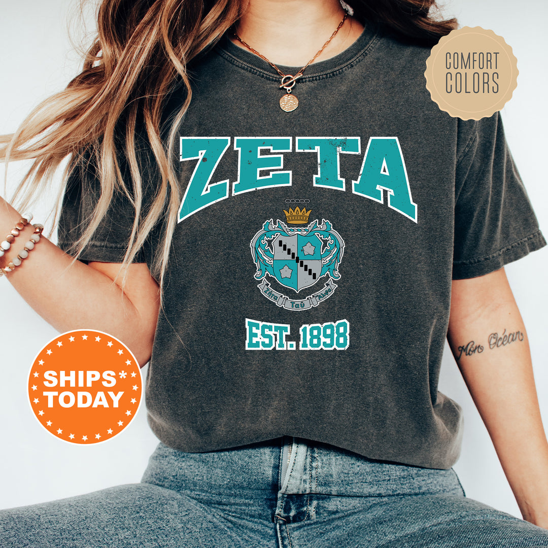 a woman wearing a zeta t - shirt and jeans
