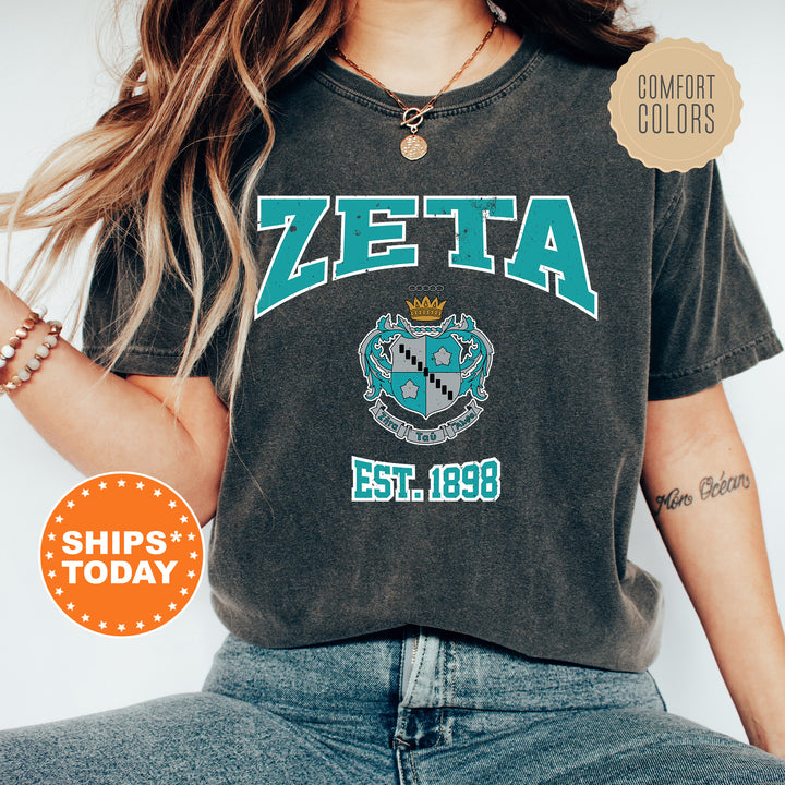 a woman wearing a zeta t - shirt and jeans