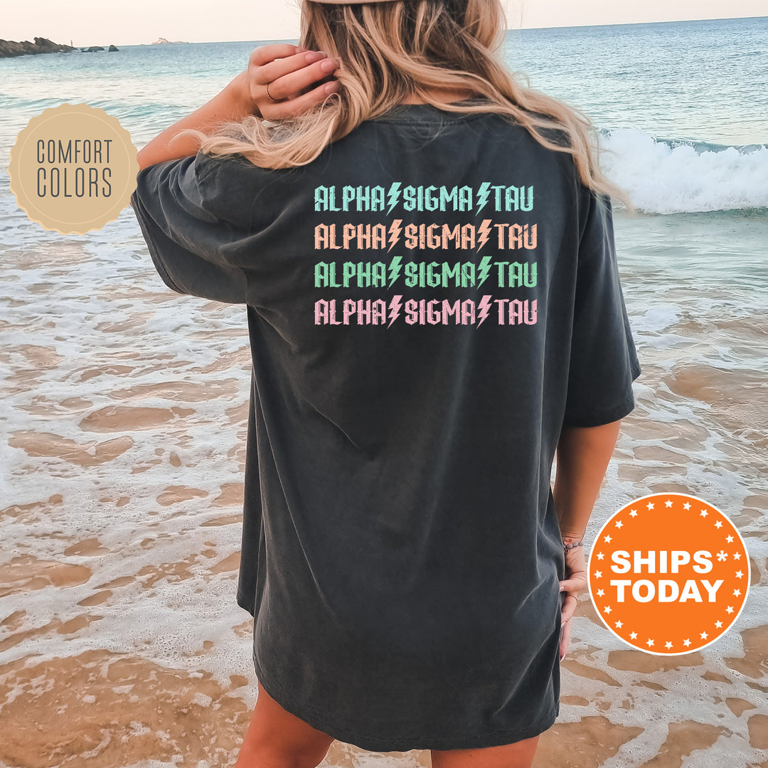 a woman standing on a beach wearing a black shirt