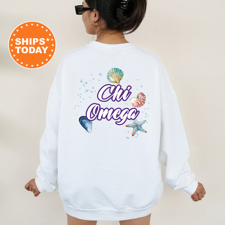 a woman wearing a white sweatshirt with the words cii omeg on it