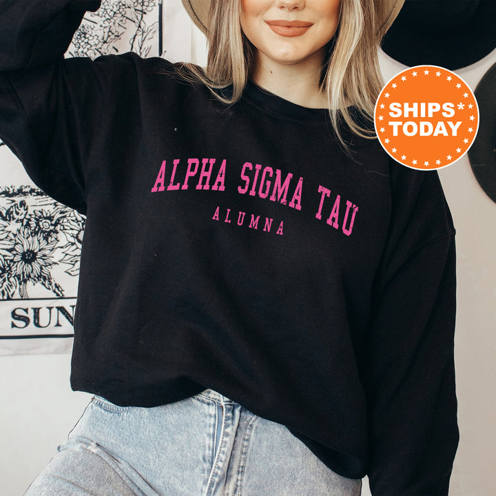 a woman wearing a black sweatshirt with pink letters on it