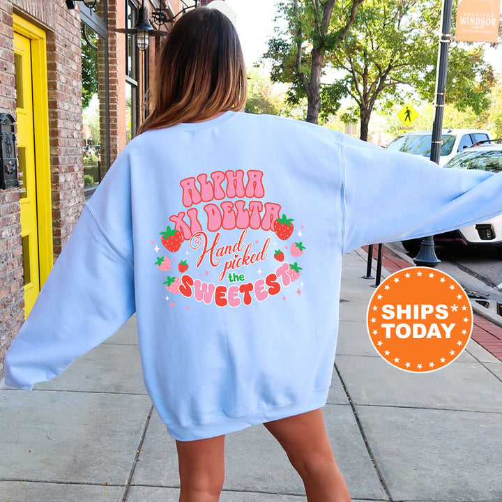 a woman walking down a sidewalk wearing a blue sweatshirt