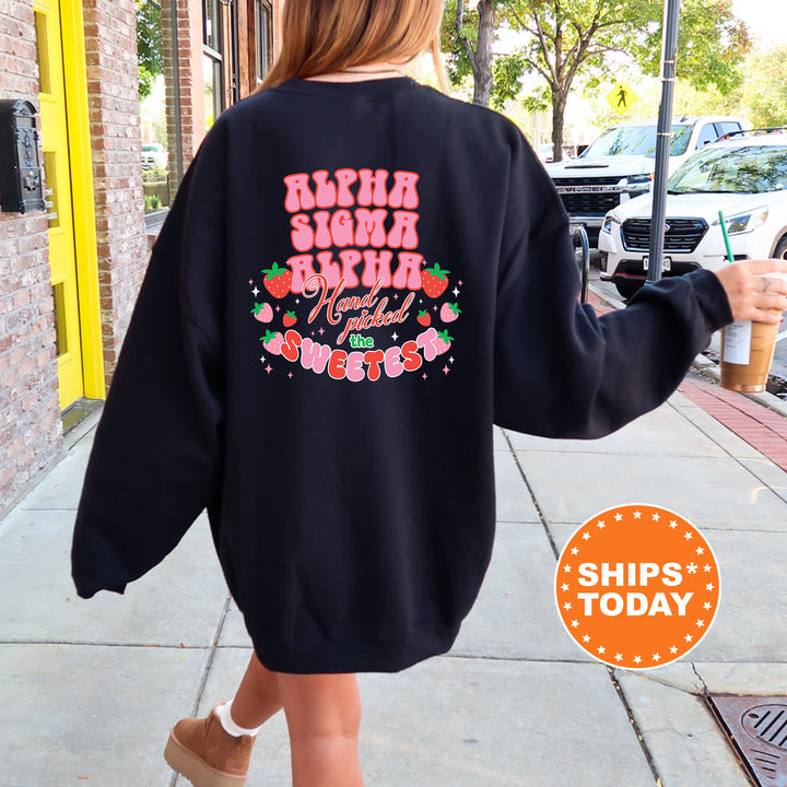 a woman walking down a sidewalk wearing a black sweatshirt