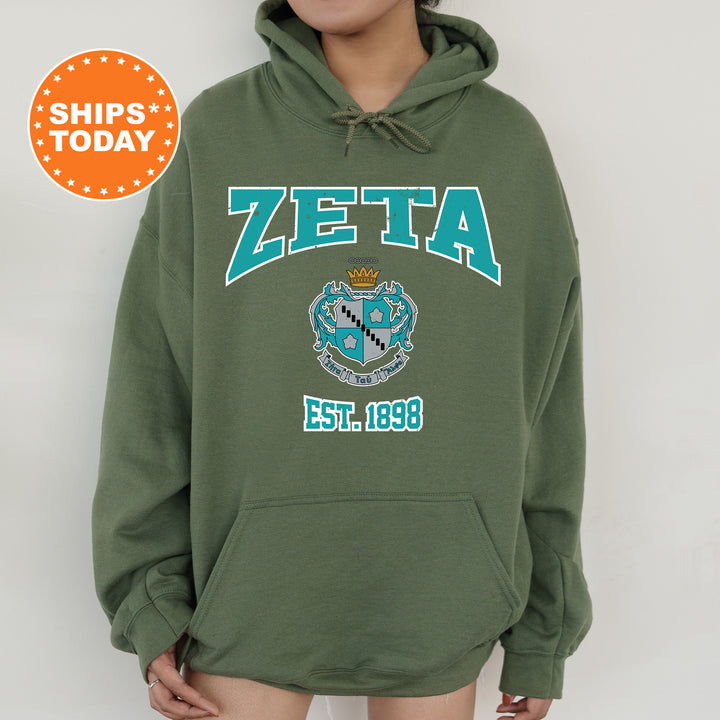 a person wearing a green hoodie with a blue and white crest on it