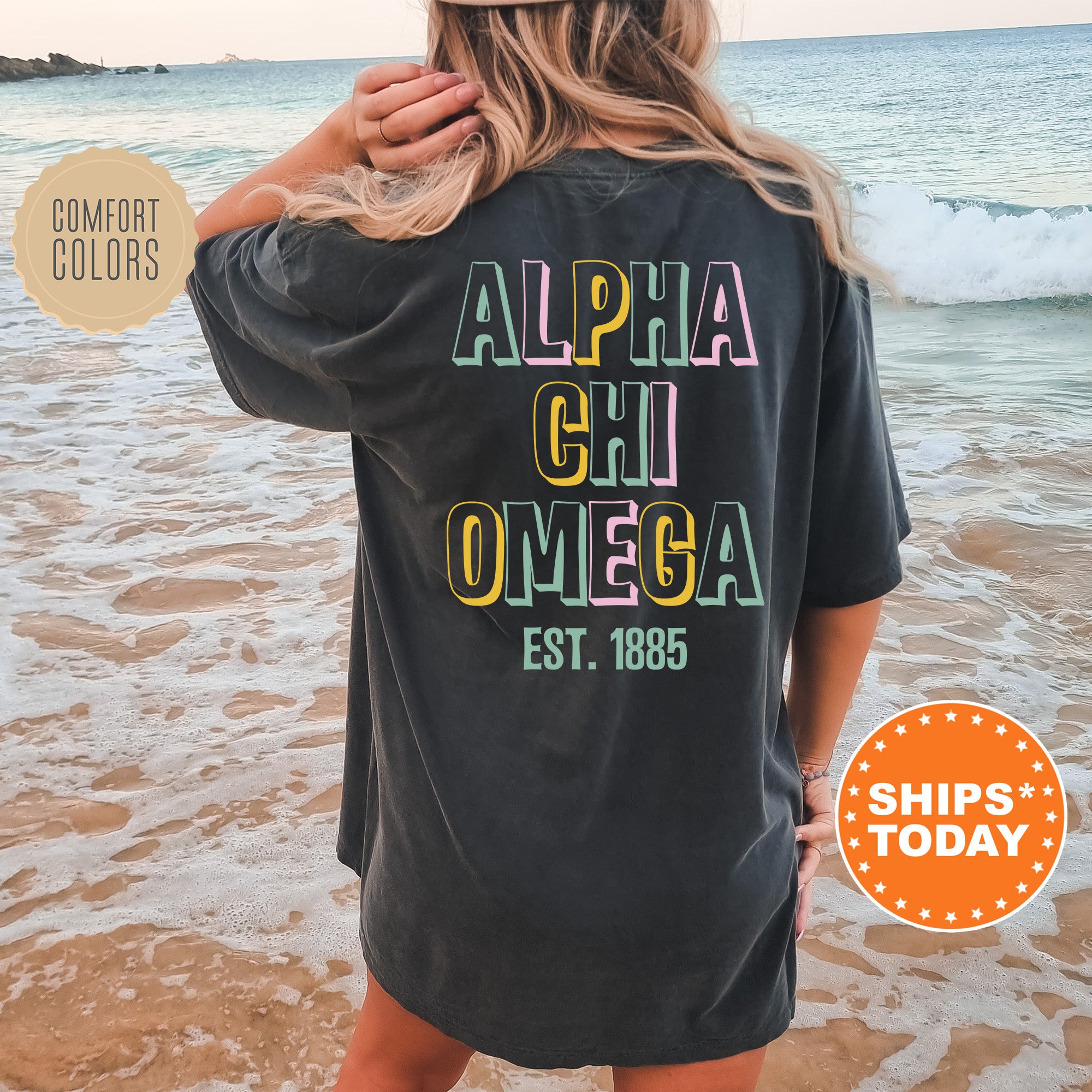 a woman standing on a beach wearing a black shirt