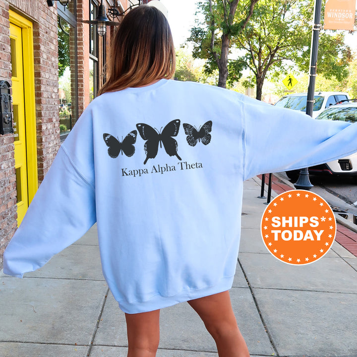 a woman walking down a sidewalk wearing a blue sweatshirt