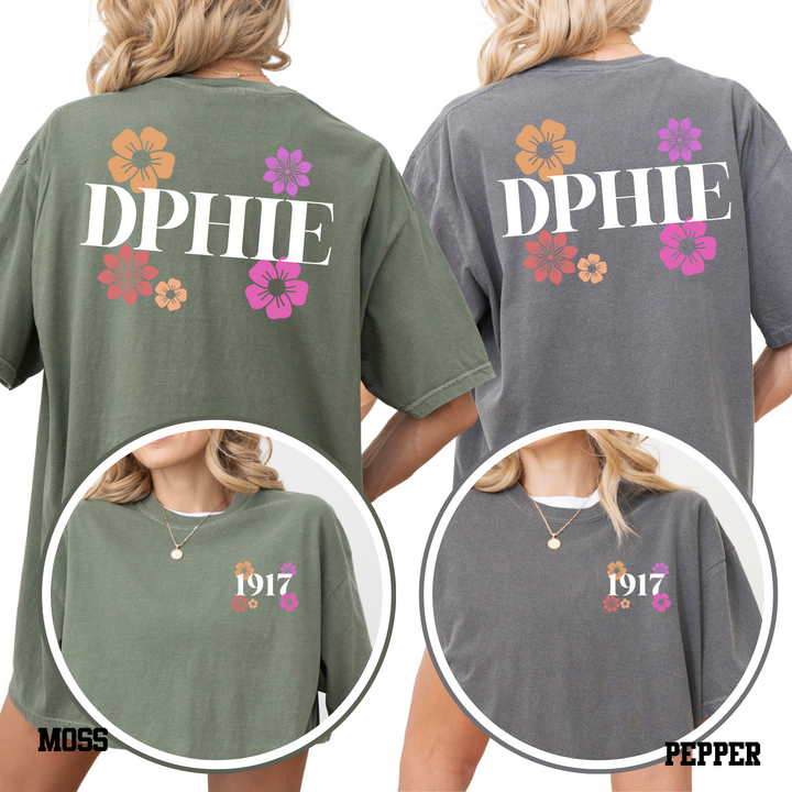 two women wearing green t-shirts with floral designs and the text "DPHIE" printed on them.