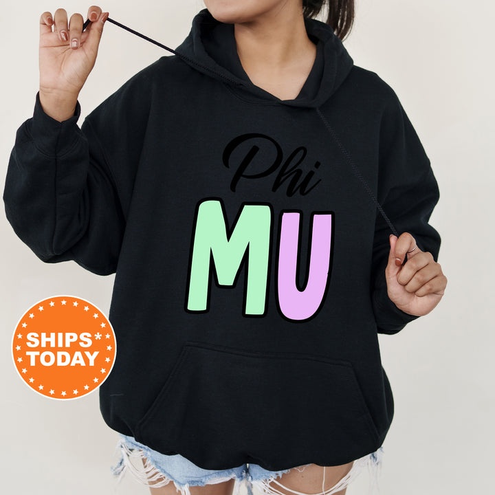 a woman wearing a black phi mu hoodie