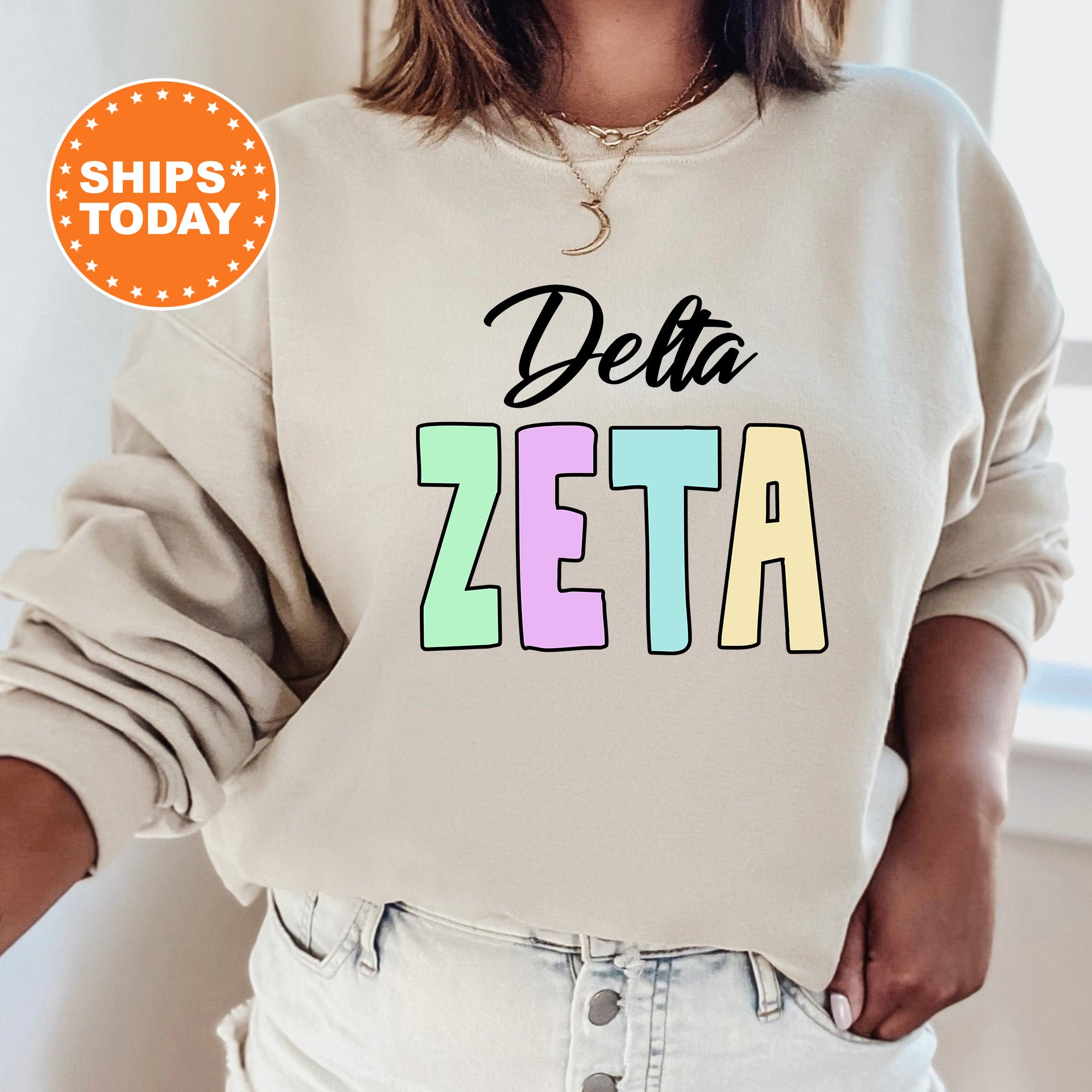 a woman wearing a sweatshirt that says delta zeta