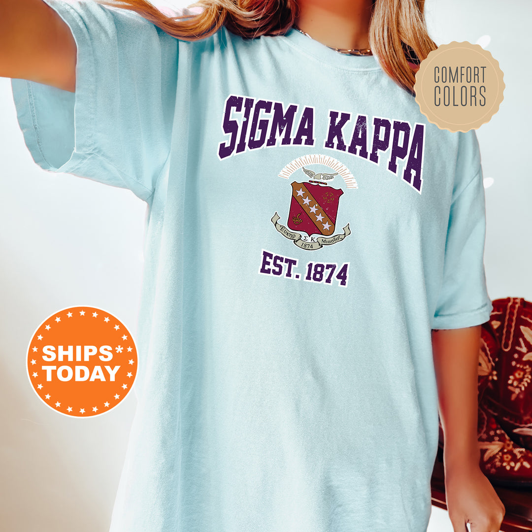 a woman wearing a blue tshirt that says stigma kappa est 1974