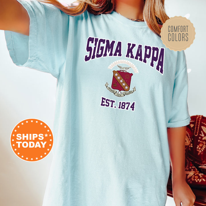 a woman wearing a blue tshirt that says stigma kappa est 1974