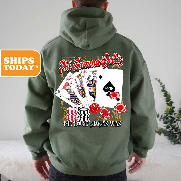 a man wearing a green hoodie with playing cards on it