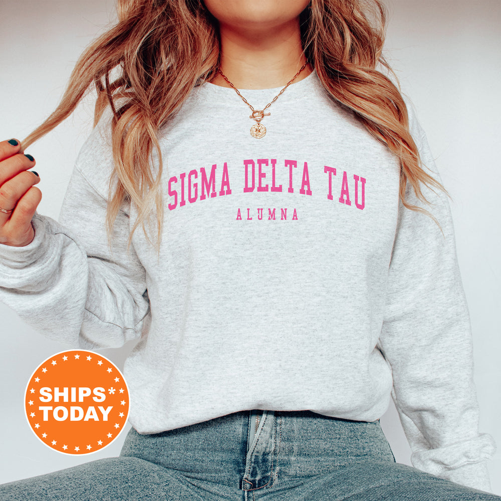 a woman wearing a sweatshirt that says stigma delta tau