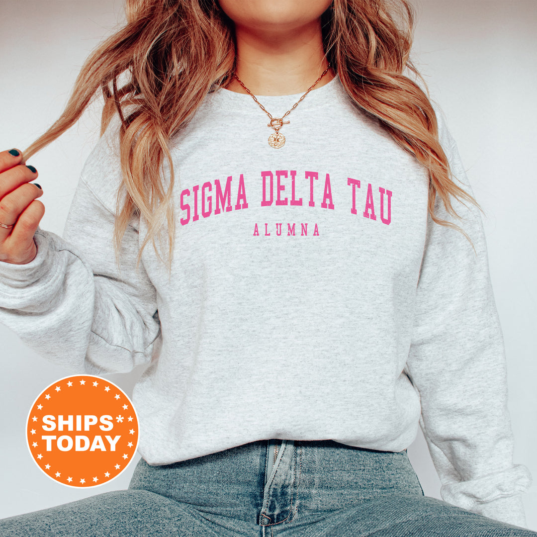 a woman wearing a sweatshirt that says stigma delta tau