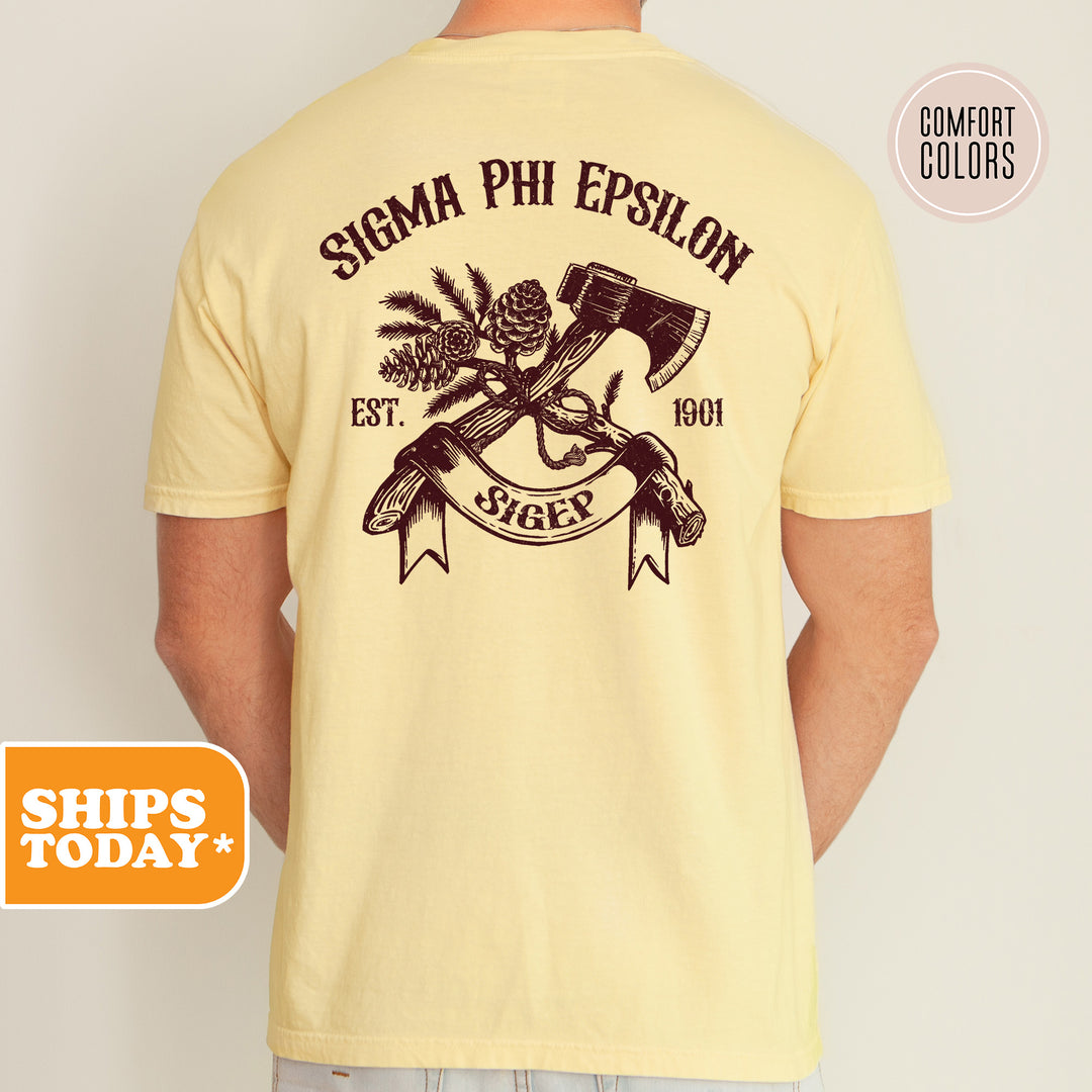 a man wearing a yellow shirt with an image of two guns on it