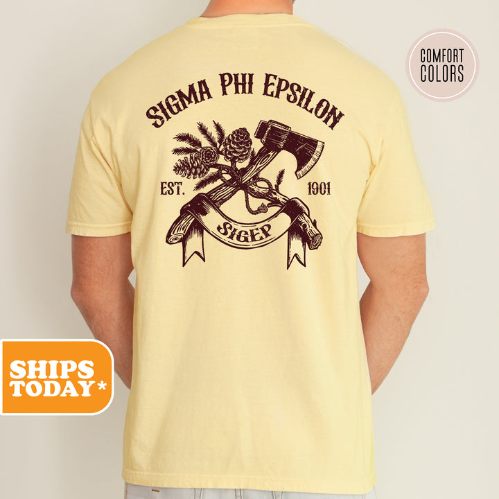 a man wearing a yellow shirt with an image of two guns on it