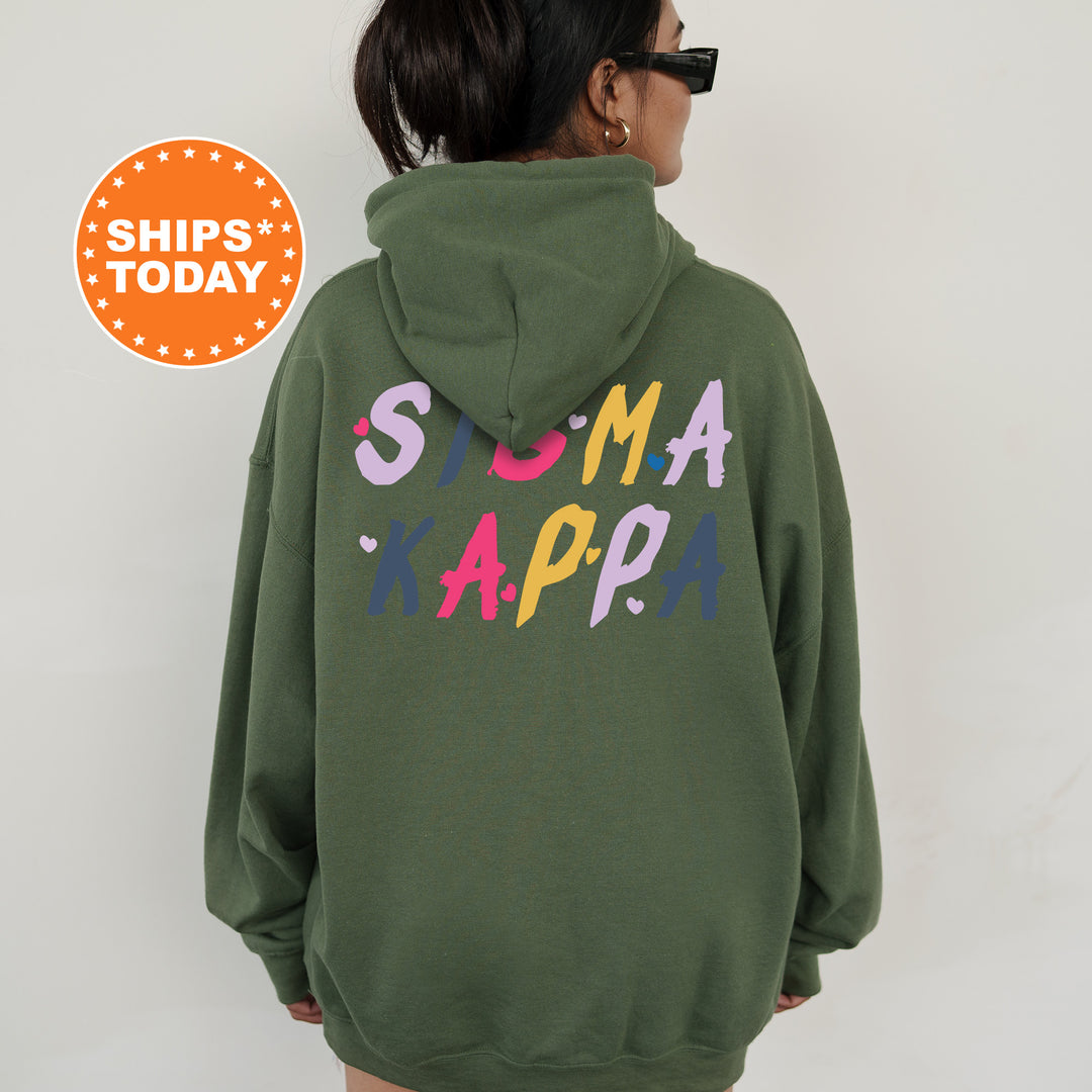 a woman wearing a green hoodie with the words suma kapa on it