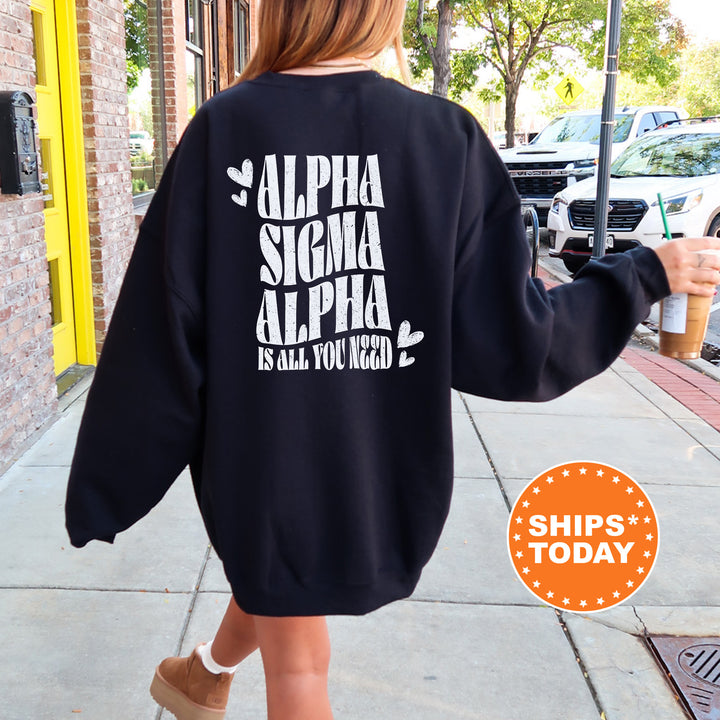 a woman walking down a sidewalk wearing a black sweatshirt