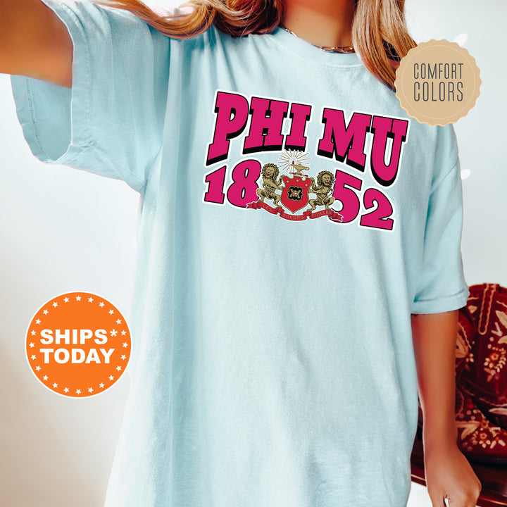a young girl wearing a phi mu shirt