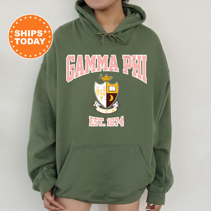 a woman wearing a green hoodie with the words gama phi on it