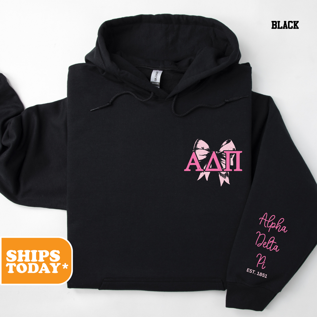 a black hoodie with pink letters on it