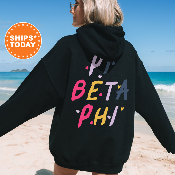 a woman wearing a black hoodie with the words phi, beta, phi