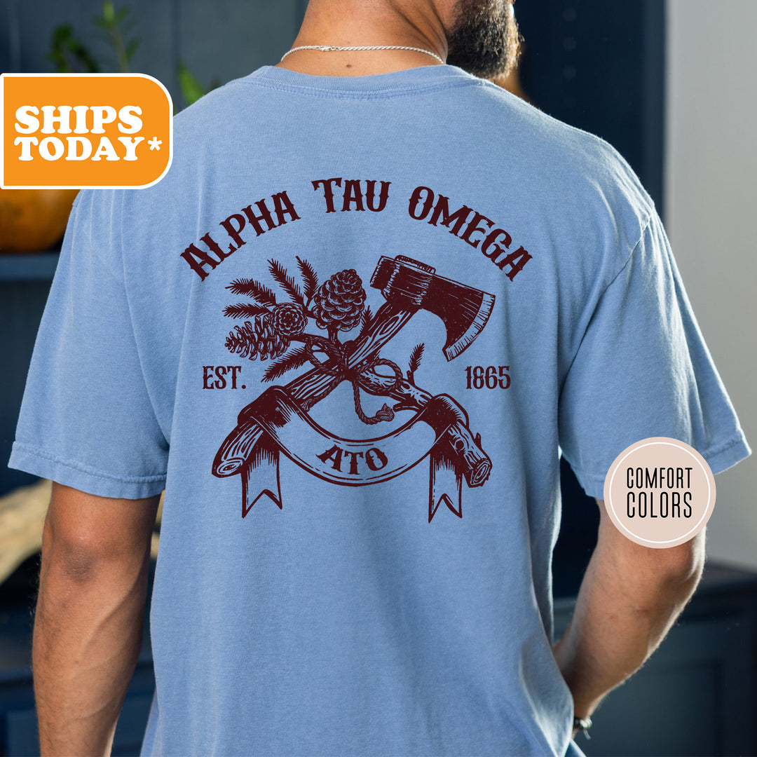 a man wearing a blue shirt with an image of a hammer and pine cones on