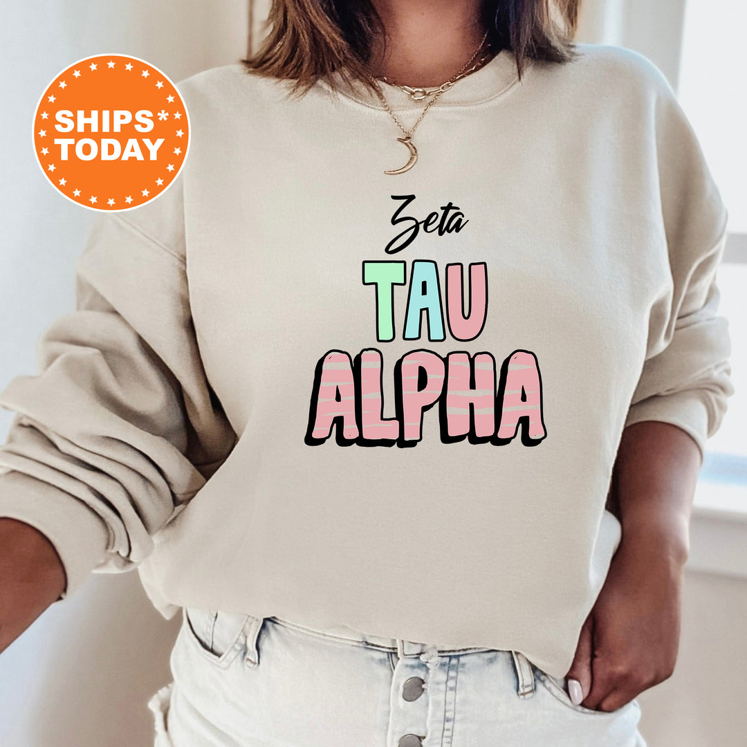 a woman wearing a sweatshirt that says stay tau alpha