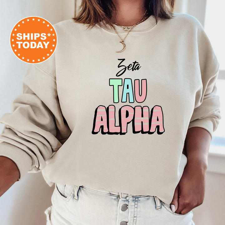 a woman wearing a sweatshirt that says stay tau alpha