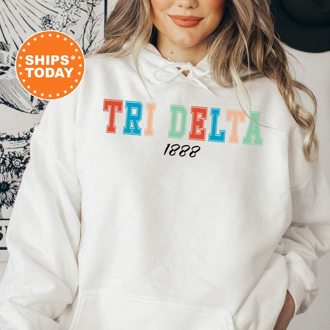 a woman wearing a white hoodie with the words tri delta printed on it