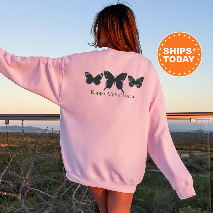 a woman wearing a pink sweatshirt with butterflies on it