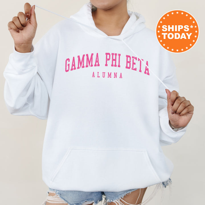 a woman wearing a white hoodie with pink letters on it