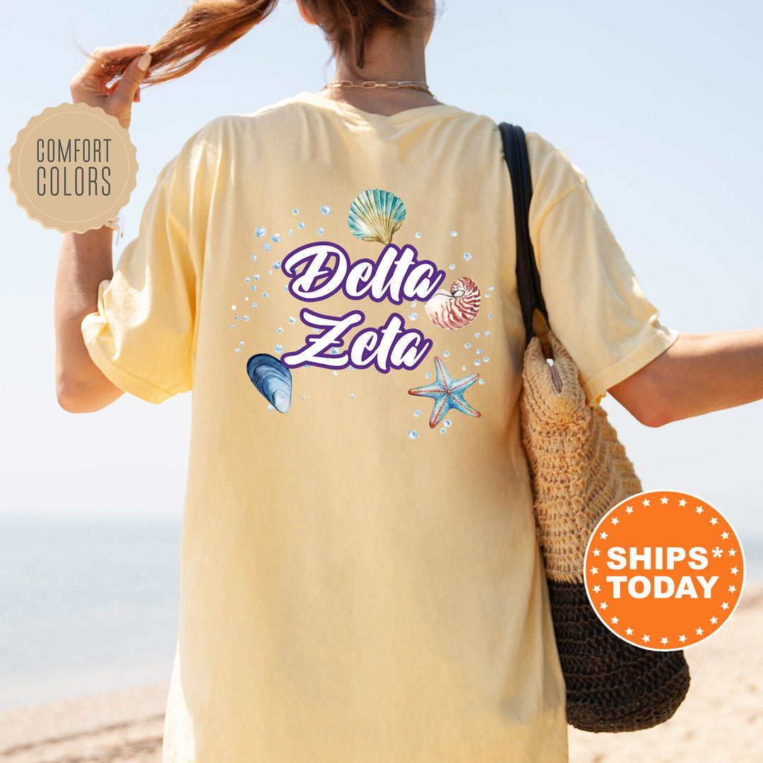 a woman walking on a beach holding a bag