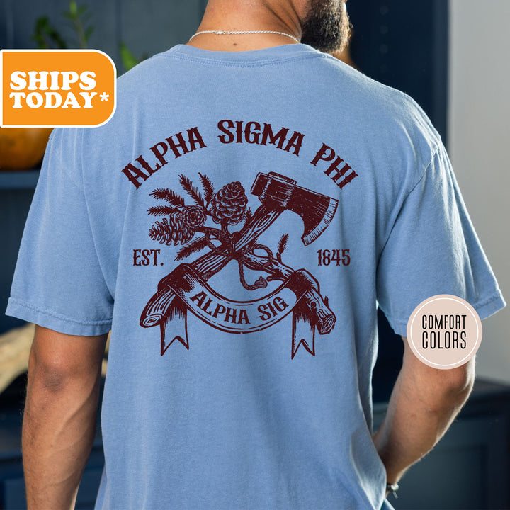 a man wearing a blue shirt with an image of a hammer and pine cones on