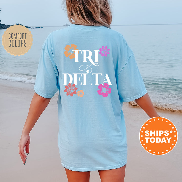 a woman walking on the beach wearing a t - shirt that says tri delta