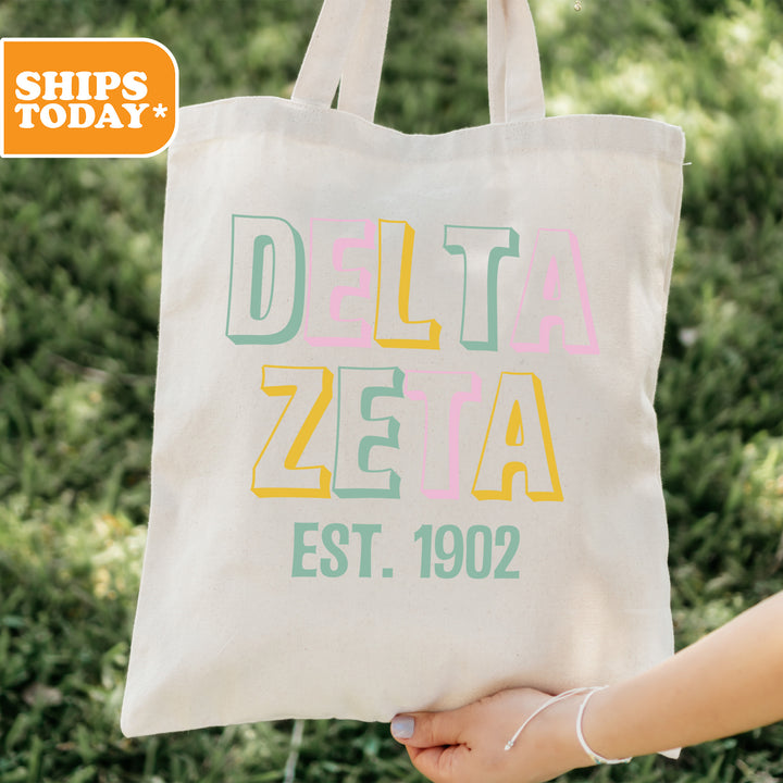 a person holding a tote bag in their hand