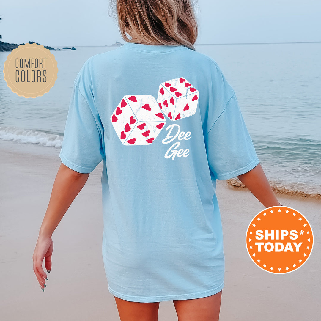 a woman walking on the beach wearing a blue shirt