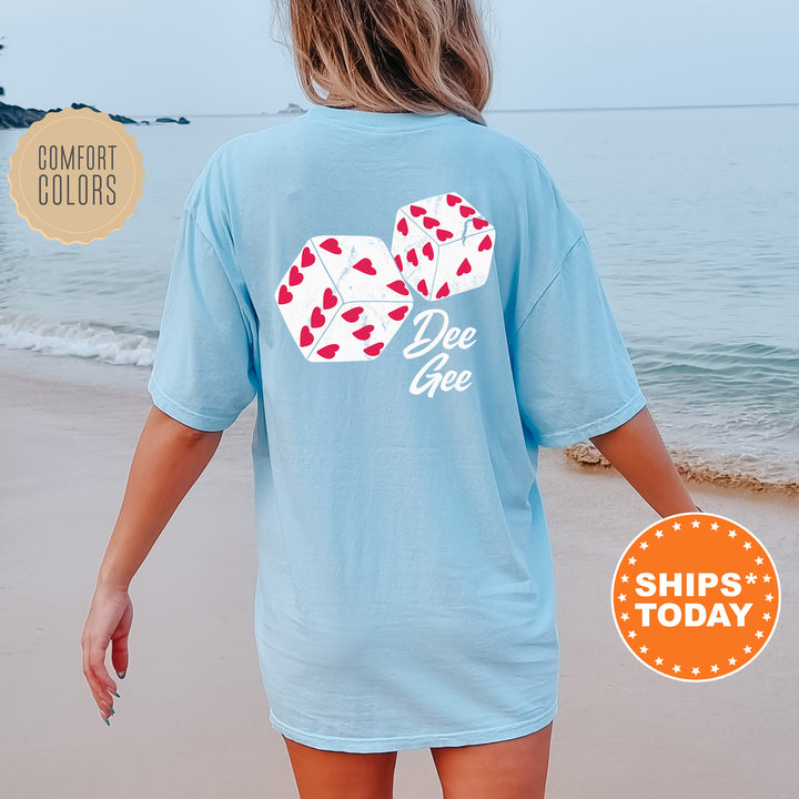 a woman walking on the beach wearing a blue shirt