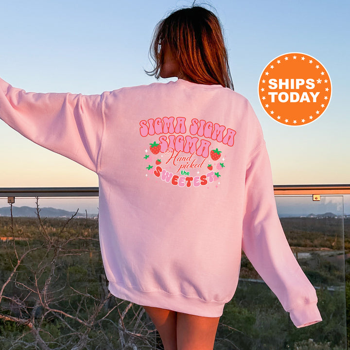 a woman in a pink sweatshirt is walking in a field