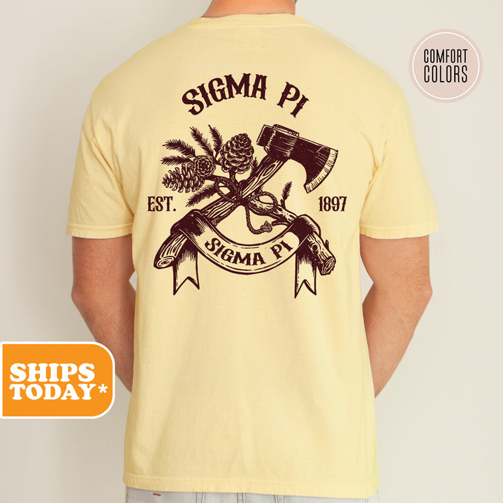 a man wearing a yellow shirt with a hammer and pine cones on it