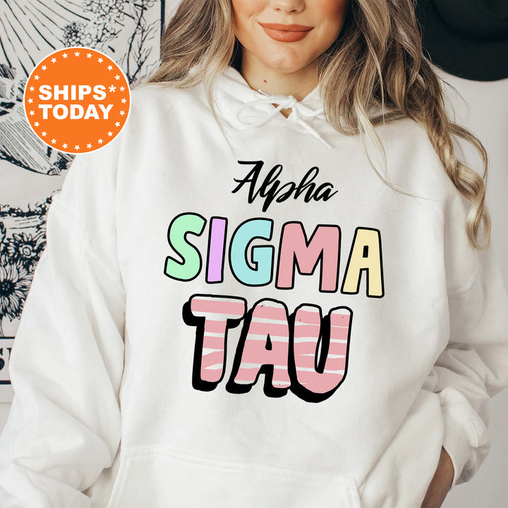 a woman wearing a white hoodie that says aloha sigma tau