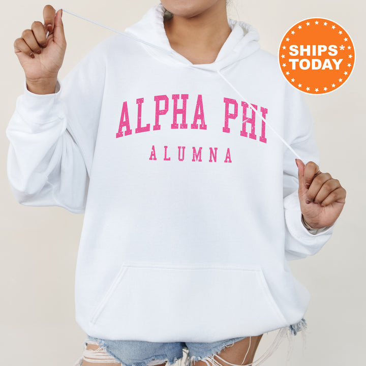 a woman wearing a white hoodie with pink letters on it