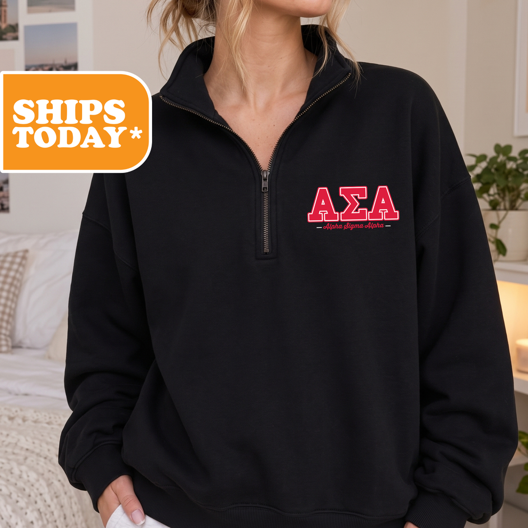 A person wearing a black zip-up sweater with the letters 'ΑΕΛΑΙ' printed on it.