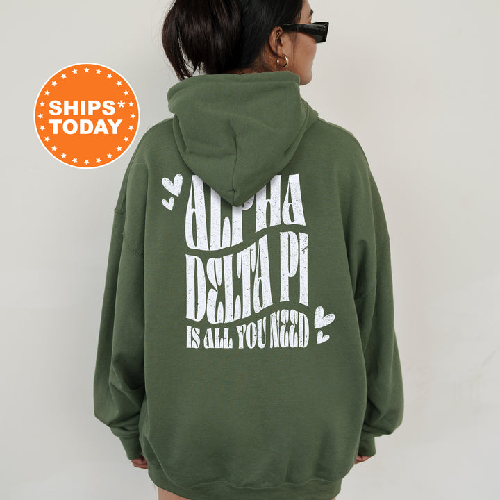 a woman wearing a green hoodie with white letters on it