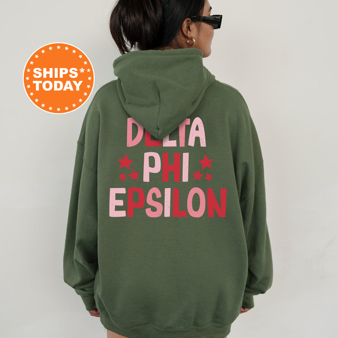 a woman wearing a green sweatshirt with the words delta phi epsion printed on it