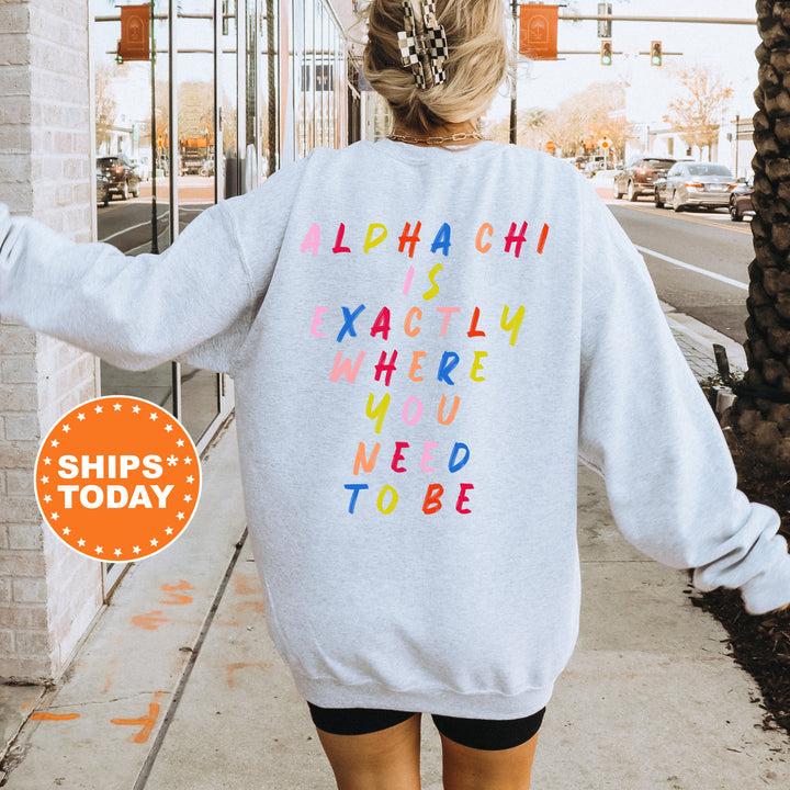 a woman walking down a sidewalk wearing a sweatshirt that says alphabet is exactly where you