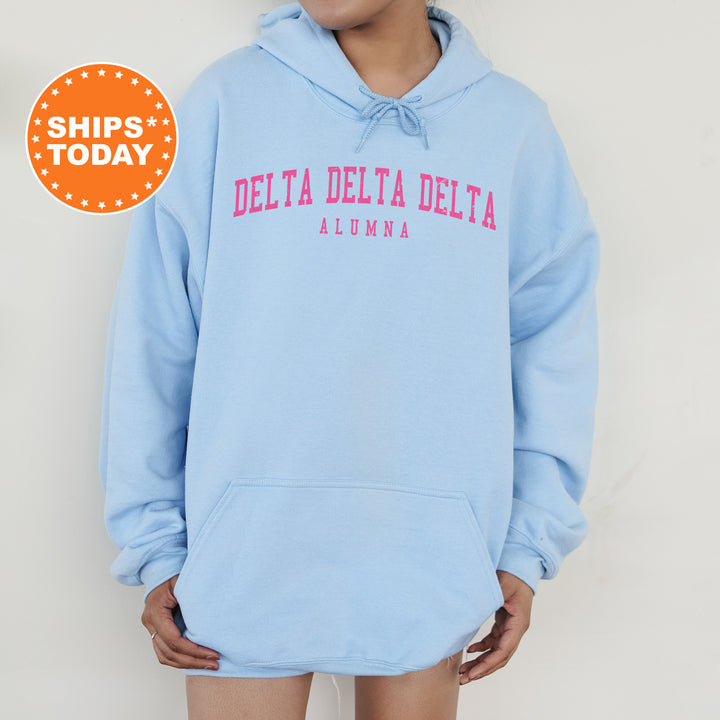 a woman wearing a blue hoodie that says delta delta delta