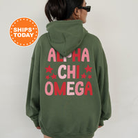 a woman wearing a green hoodie with pink letters on it