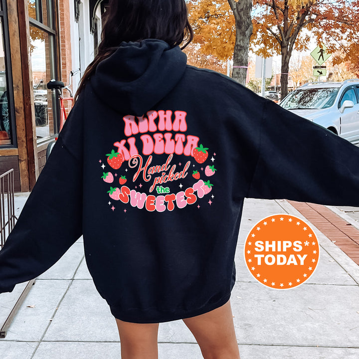 a woman in a black hoodie is walking down the street